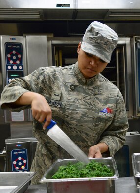 Airman 1st Class Linsun Jackson, 51st Force Support Squadron food service specialist, prepares spinach for lunch April 1, 2015, at Osan Air Base, Republic of Korea. The dining facilities serve not only the 51st Fighter Wing, but also the 7th Air Force, numerous tenant units and deployed personnel. (U.S. Air Force photo by Senior Airman Matthew Lancaster)