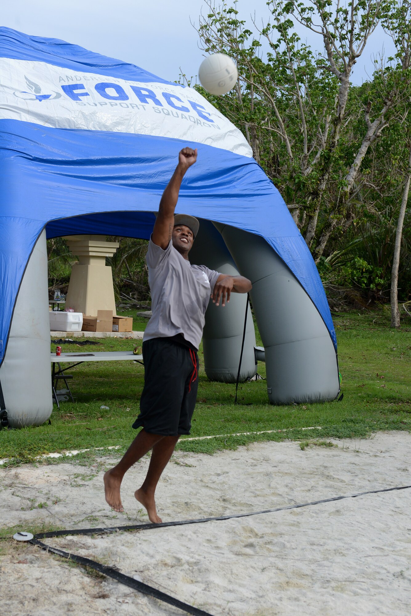 Edward Thomas, part of the first sergeants team, serves a ball during a commanders vs. first sergeants beach volleyball tournament June 5, 2015, on Tarague Beach at Andersen Air Force Base, Guam. The first sergeants beat the commanders during the first match of the tournament and won the final match against the First Four Airmen. (U.S. Air Force photo by Airman 1st Class Arielle Vasquez/Released)
