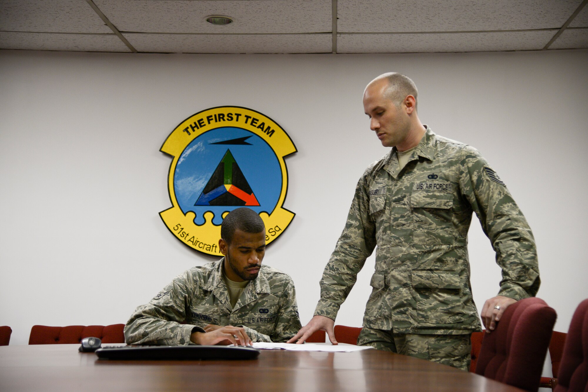 Tech. Sgt. Shayne Taglieri, 51st Aircraft Maintenance Squadron noncommissioned officer in charge of administrative support, reviews paperwork with a coworker June 8, 2015, at Osan Air Base, Republic of Korea. Taglieri was selected as this week's Airman spotlight, signifying his status as one of Team Osan's best. (U.S. Air Force photo by Staff Sgt. Jake Barreiro)