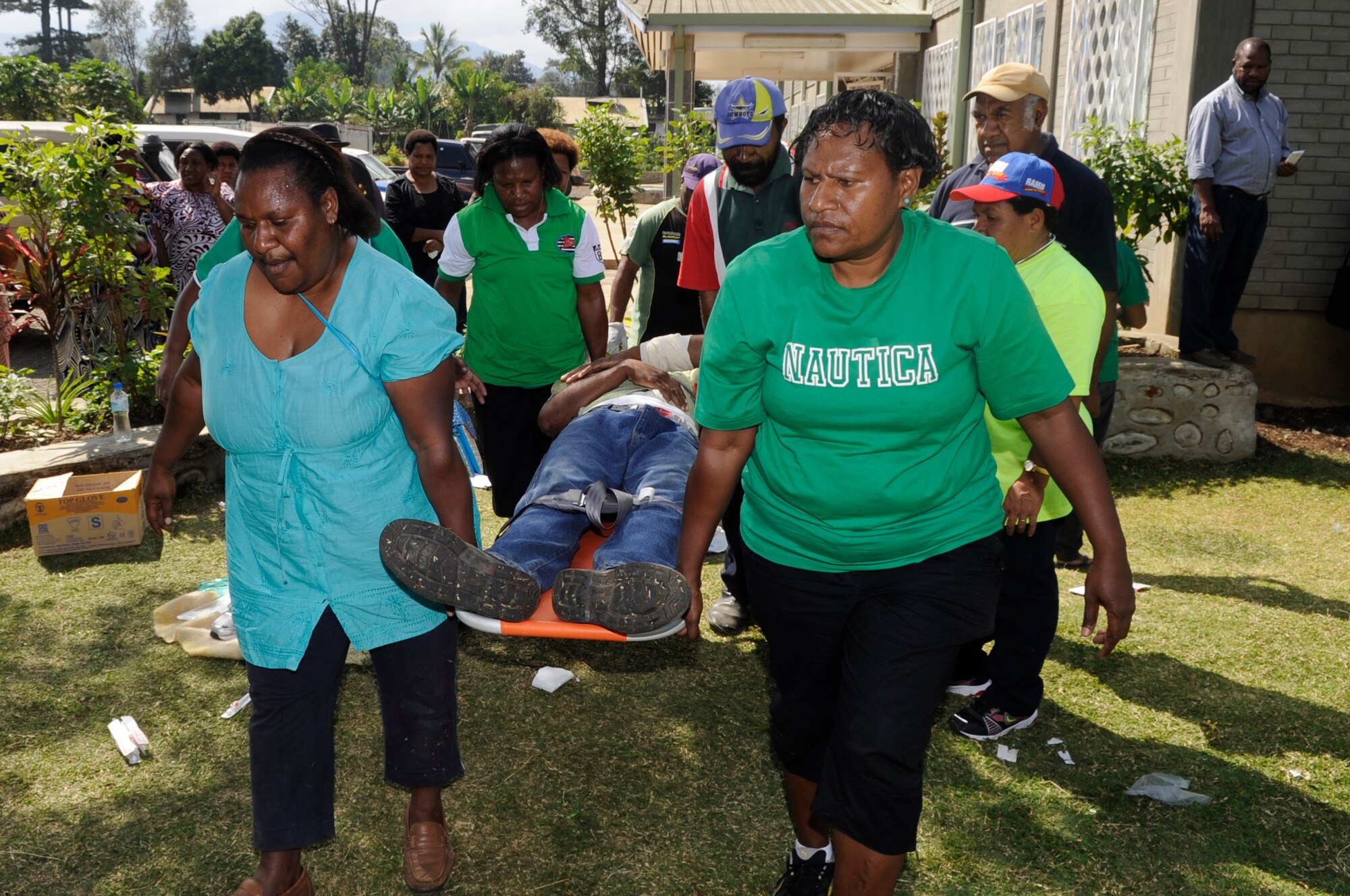 Medical personnel from Goroka Hospital litter carry a simulated wounded civilian during a mass casualty exercise for Pacific Angel 15-4 at Goroka Health Clinic, Papua New Guinea, June 5, 2015. Efforts undertaken during Pacific Angel help multilateral militaries in the Pacific improve and build relationships across a wide spectrum of civic operations, which bolsters each nation???s capacity to respond and support future humanitarian assistance and disaster relief operations. (U.S. Air Force photo by Staff Sgt. Marcus Morris/Released)