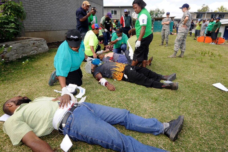 Medical personnel from Goroka Hospital treat simulated wounded civilians during a mass casualty exercise for Pacific Angel 15-4 at Goroka Health Clinic, Papua New Guinea, June 5, 2015. The U.S. military trained the medical staff on mass casualty triage, how to make tourniquets and litters out of things lying around and how to carry wounded patients. (U.S. Air Force photo by Staff Sgt. Marcus Morris/Released)