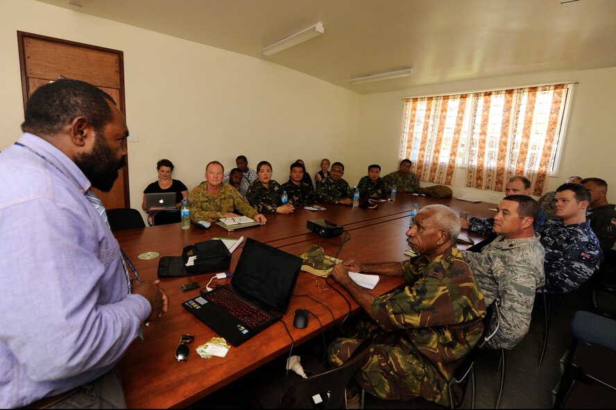 Dr. Max Manape, of the Eastern Highlands Provincial Health Authority in Papua New Guinea, talks about waterborne diseases and the challenges of treating isolated provinces to military doctors from the U.S., Australia, Philippines, Indonesia and Papua New Guinea Defence Force, along with Institute of Medical Research experts during Pacific Angel 15-4 at Goroka, Papua New Guinea, June 4, 2015. The doctors and researchers shared their knowledge of diseases and discussed how best to treat and prevent them from occurring. Efforts undertaken during Pacific Angel help multilateral militaries in the Pacific improve and build relationships across a wide spectrum of civic operations, which bolsters each nation???s capacity to respond and support future humanitarian assistance and disaster relief operations. (U.S. Air Force photo by Staff Sgt. Marcus Morris/Released)