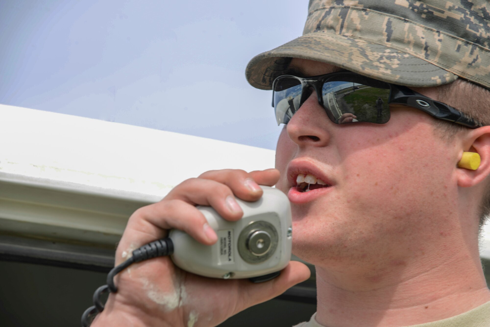 U.S. Air Force Airman First Class Adam Pryor, a 354th Civil Engineer Squadron pavements and heavy equipment journeyman, communicates with the control room during his shift May 15, 2015, at Eielson Air Force Base, Alaska. The control room is available to relay any information to Airmen while out on assignments. (U.S. Air Force photo by Senior Airman Ashley Nicole Taylor/Released)