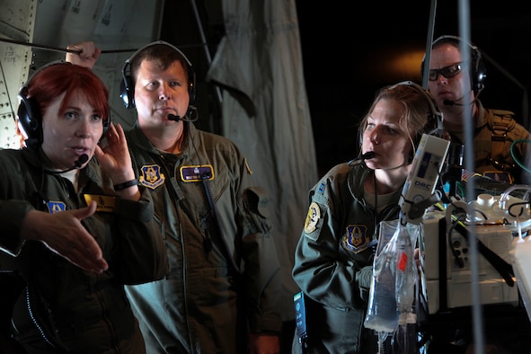 Critical care air transport teams and aeromedical evacuation crewmembers practice transporting critically ill patients on a C-130J Super Hercules from the California Air National Guard's 146th Airlift Wing, Channel Islands Air National Guard Station, California. during 349th Air Mobility Wing Air Force Specialty Code training June 6, 2015, at Travis Air Force Base, California.  In preparation for the training, the 349th Aeromedical Evacuation Squadron transformed the four-engine tactical transport into a flying hospital. In turn, the CCATT teams from the 60th Surgical Operations Squadron and the 349th Aeromedical Staging Squadron established onboard what was essentially a portable intensive care unit dedicated to one very ill, simulated, "patient."  (U.S. Air Force photo/Lt. Col. Robert Couse-Baker/Released)