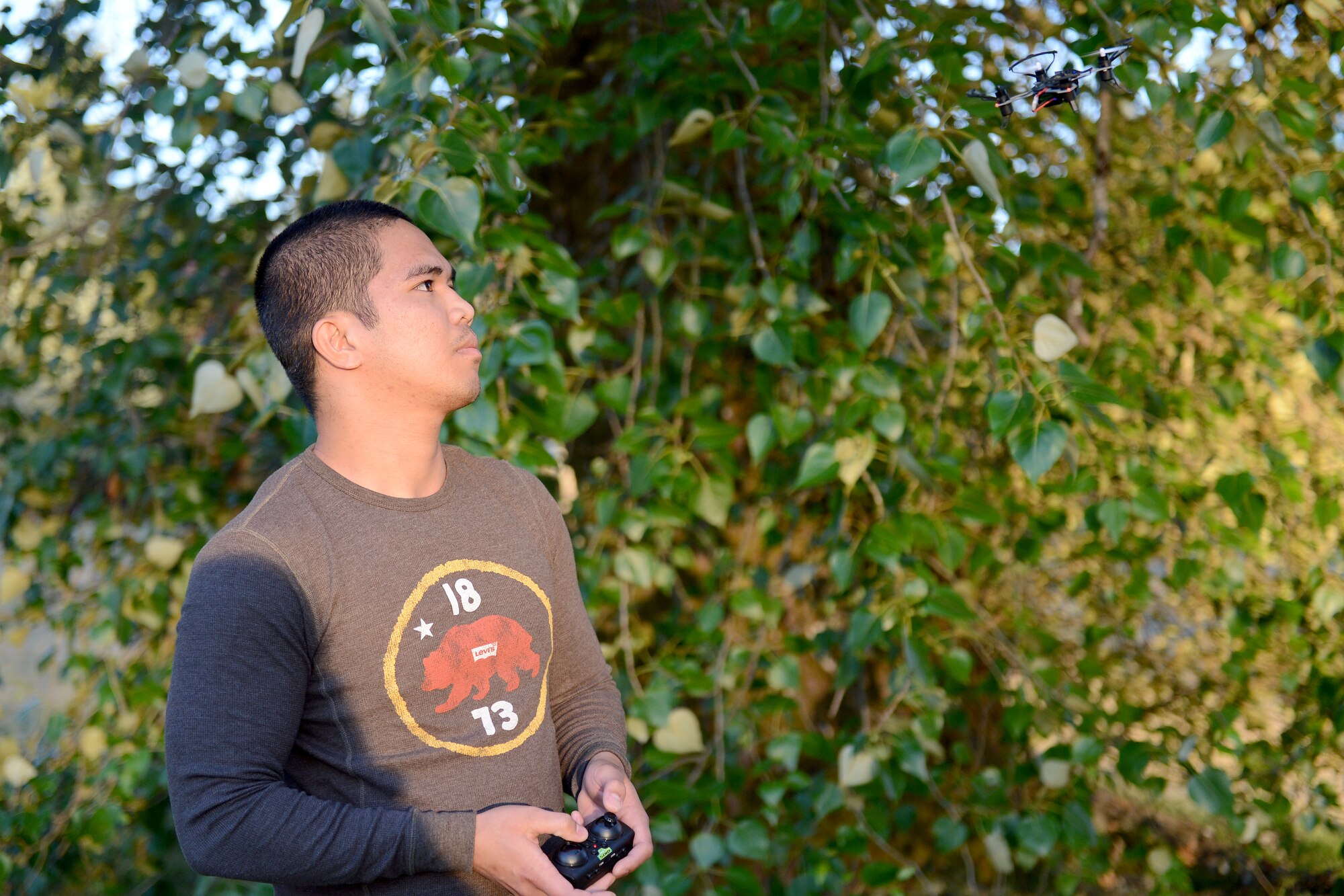 Airman 1st Class Rubert Bantigue, 627th Logistics Readiness Squadron refueling truck mechanic, flies his quadcopter, June 7, 2015, at Fort Steilacoom Park in Lakewood, Wash. Drones present a hazard because of the risk of midair collision with larger aircraft due to the difficulty in detecting and communicating with the owner. (U.S. Air Force photo/Airman 1st Class Keoni Chavarria)