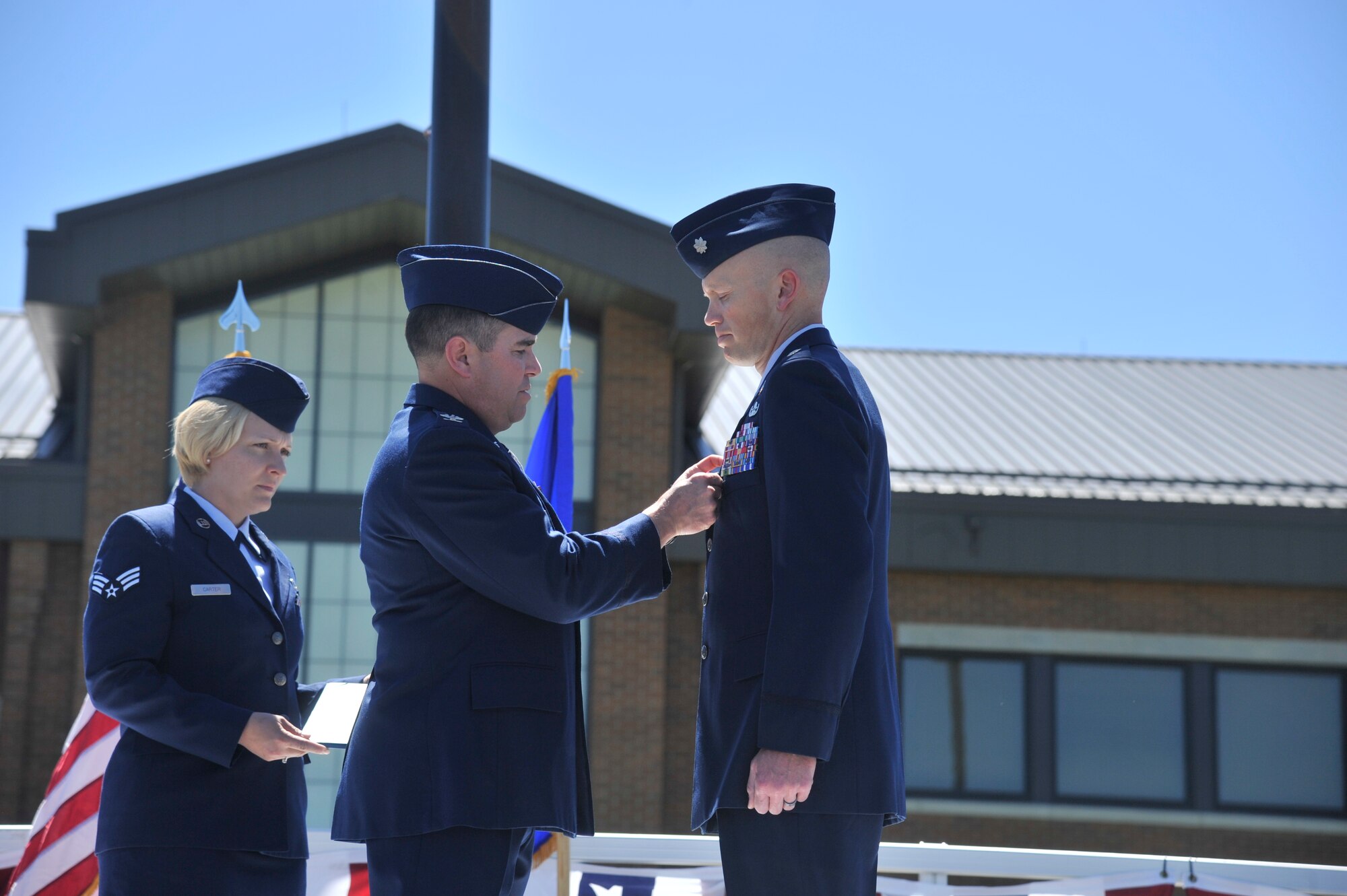 Col. Jonathan Duncan, the 336th Training Group commander, pins a second oak leaf cluster medal on Lt. Col. Kelly Hannum the former 336th Training Support Squadron commander, June 5, 2015, at Fairchild Air Force Base, Wash. Hannum received the second oak leaf cluster for the Meritorious Service Medal. (U.S. Air Force photo/ Airman 1st Class Taylor Bourgeous)