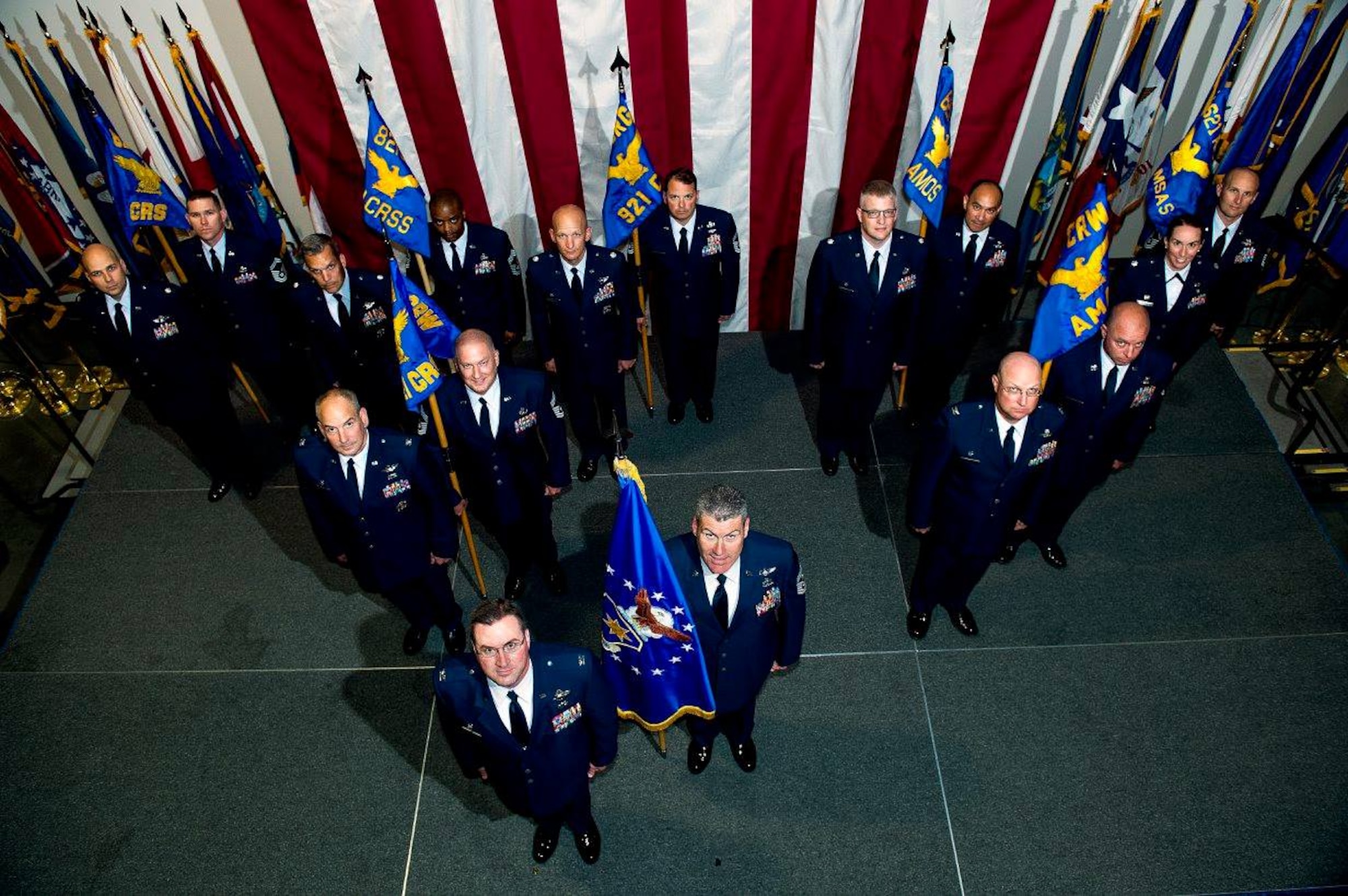 The new 621st Contingency Response Wing commanders at Travis Air Force Base pose in reorganization structure order after a ceremony June 4, 2015. The reorganization process initiated May 28, when the 817th Global Mobility Squadron and Global Mobility Readiness Squadron deactivated and the 621st Contingency Response Squadron activated. This date marks the beginning of the inactivation of 17 units and formation of 12 newly activated units culminating on June 26. (U.S. Air Force photo/Tech. Sgt. Matthew Hannen)