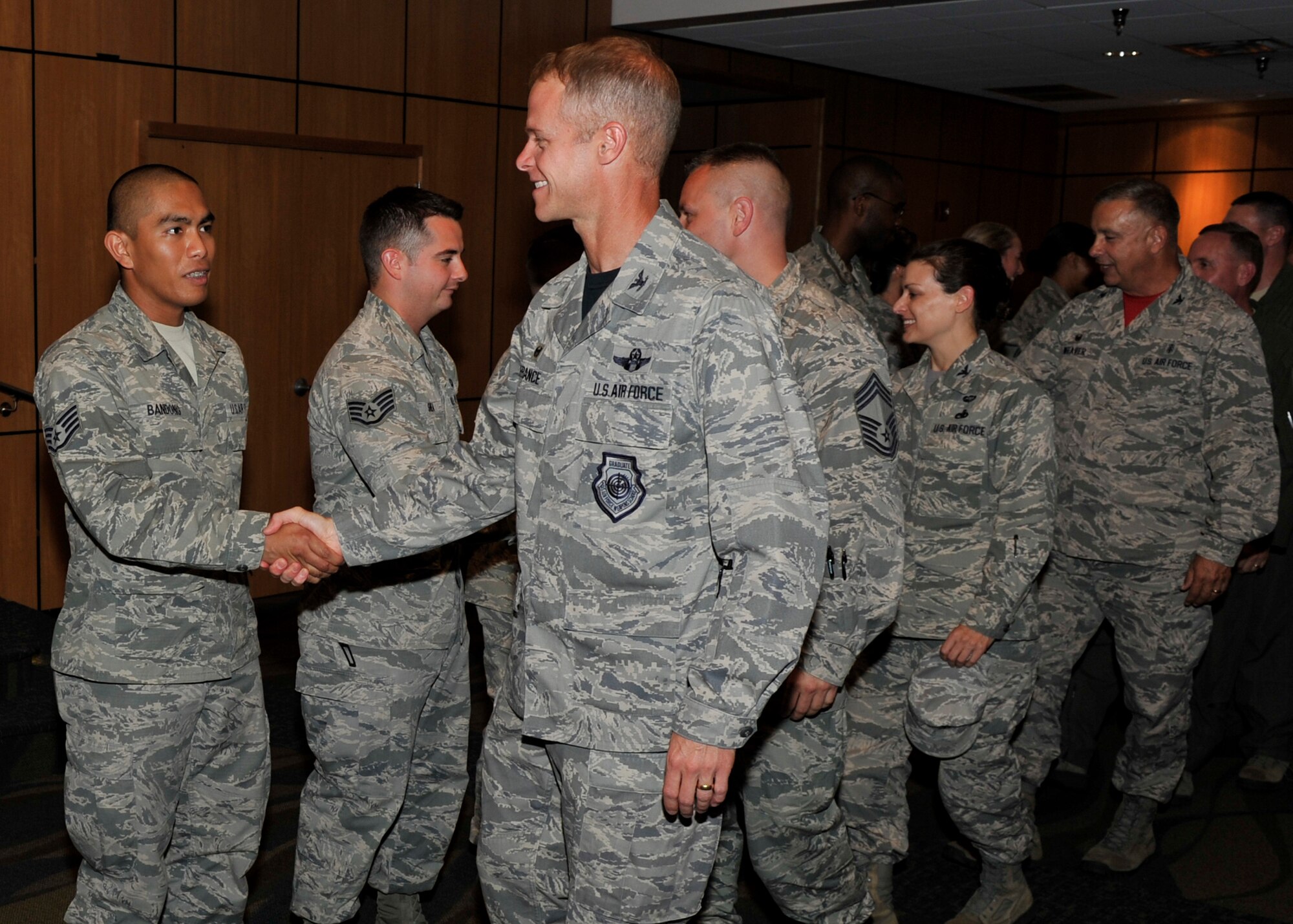 Colonel Derek C. France, 325th Fighter Wing commander, and members of Team Tyndall congratulate the June promotees May 29. (U.S. Air Force photo by Airman 1st Class Sergio A. Gamboa/Released)
