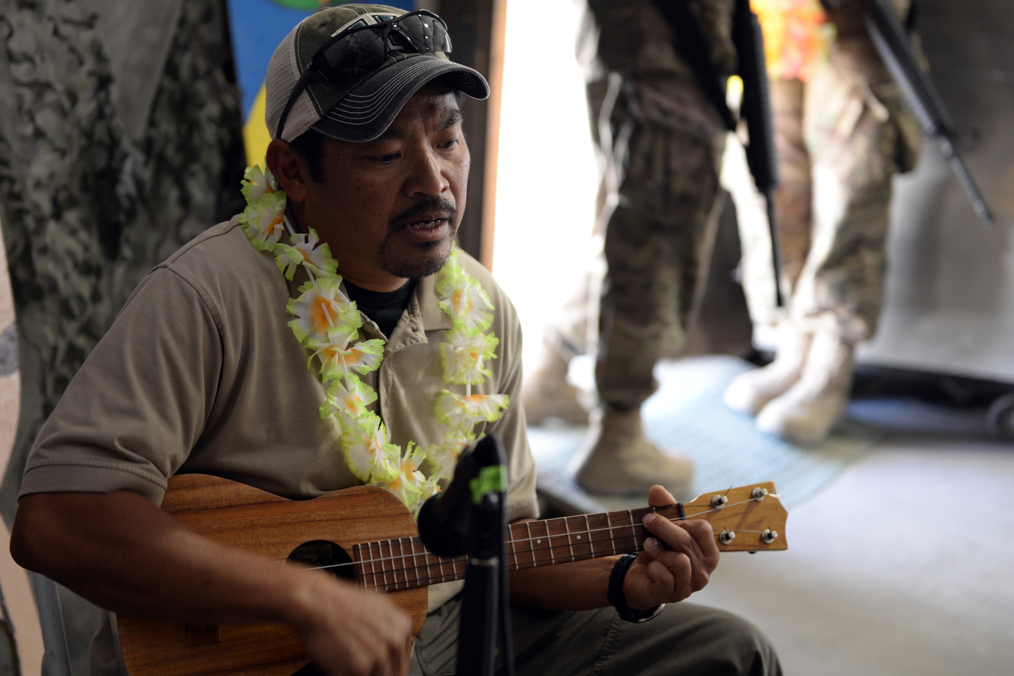 Clyd Sadang, 455th Expeditionary Security Forces Squadron contract engineer, plays a ukulele during the Bagram culture day event May 5, 2015 at Bagram Air Field, Afghanistan. The event was held to bring members of different backgrounds from across BAF together to learn and share each other’s cultures. (U.S. Air Force photo by Senior Airman Cierra Presentado/ Released)