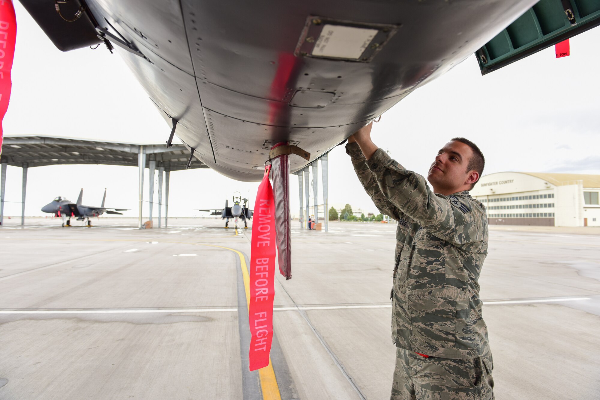 Senior Airman Austin Fifield, 414th Maintenance Squadron avionics system technician, inspects systems on an F-15E Strike Eagle on the flightline at Mountain Home Air Force Base, Idaho June 1. Fifield, temporarily assigned to the 391st Aircraft Maintenance Unit, is one of 10 reservists from Seymour Johnson Air Force Base, N.C., serving in an active duty capacity with the 366th Maintenance Group.  (U.S. Air Force photo Staff Sgt. Lausanne Kinder)
