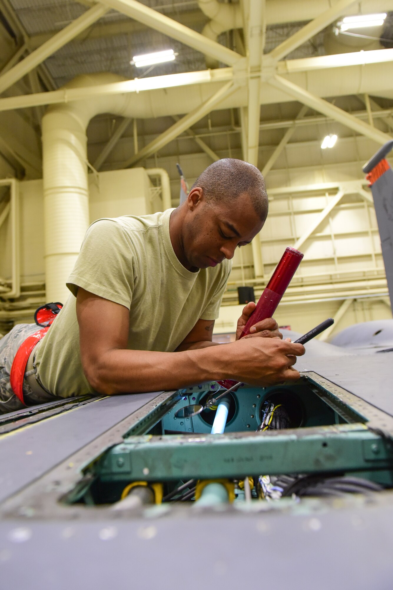 Staff Sgt. Stephen Young, 414th Maintenance Squadron crew chief, inspects the inside of a panel on an F-15E Strike Eagle during a routine 400-hour phase inspection at Mountain Home Air Force Base, Idaho, June 1. An aircraft that has reached a certain number of flying hours must go through more in-depth inspections to ensure it maintains its flight safety status.  (U.S. Air Force photo Staff Sgt. Lausanne Kinder)