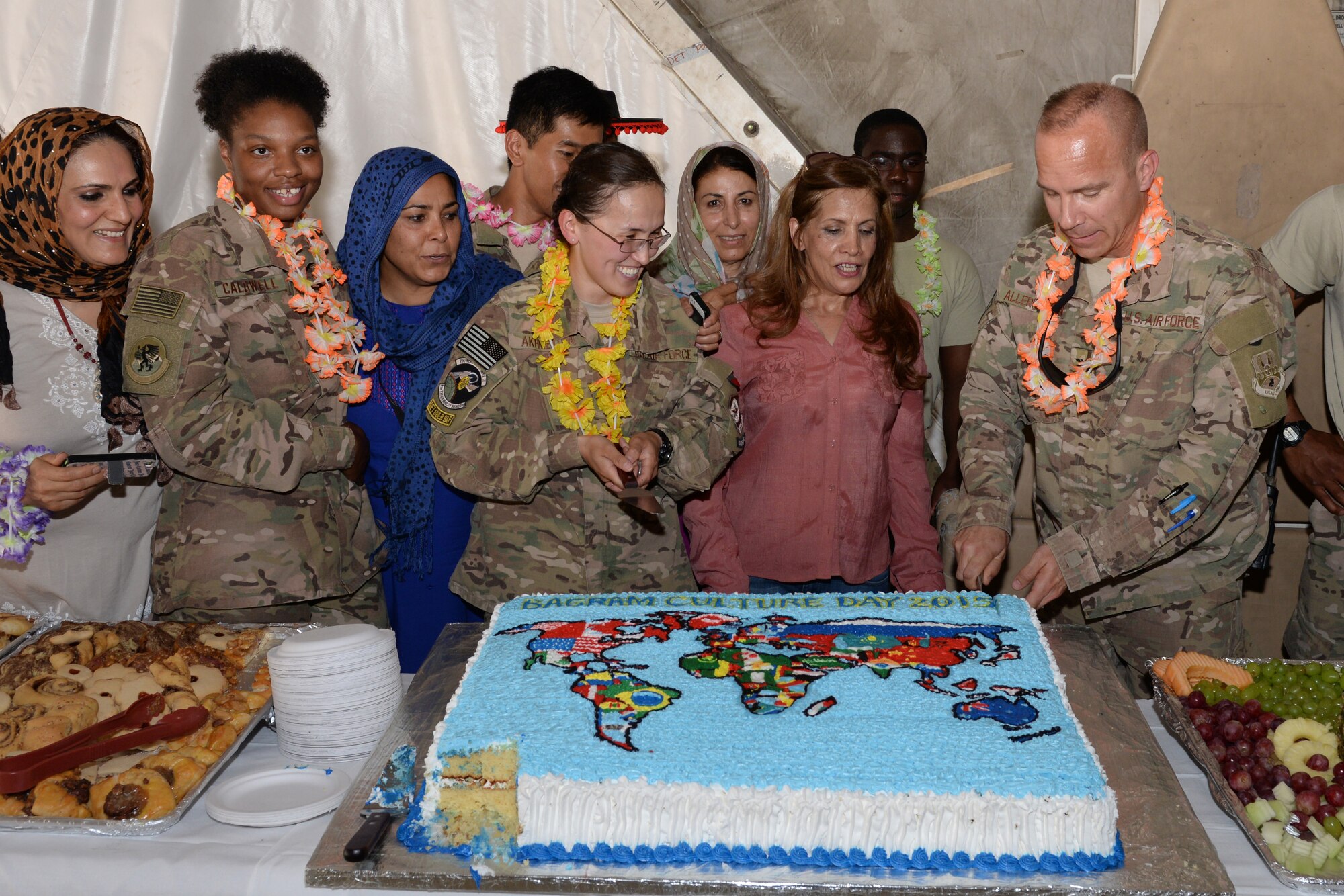 U.S. Air Force Col. Nathan Allerheiligen, 455th Air Expeditionary Wing vice commander, cuts a cake during the Bagram culture day event May 5, 2015, at Bagram Air Field, Afghanistan. The event was held to bring members of different backgrounds across BAF to learn and share each other’s cultures. (U.S. Air Force photo by Senior Airman Cierra Presentado/ Released)