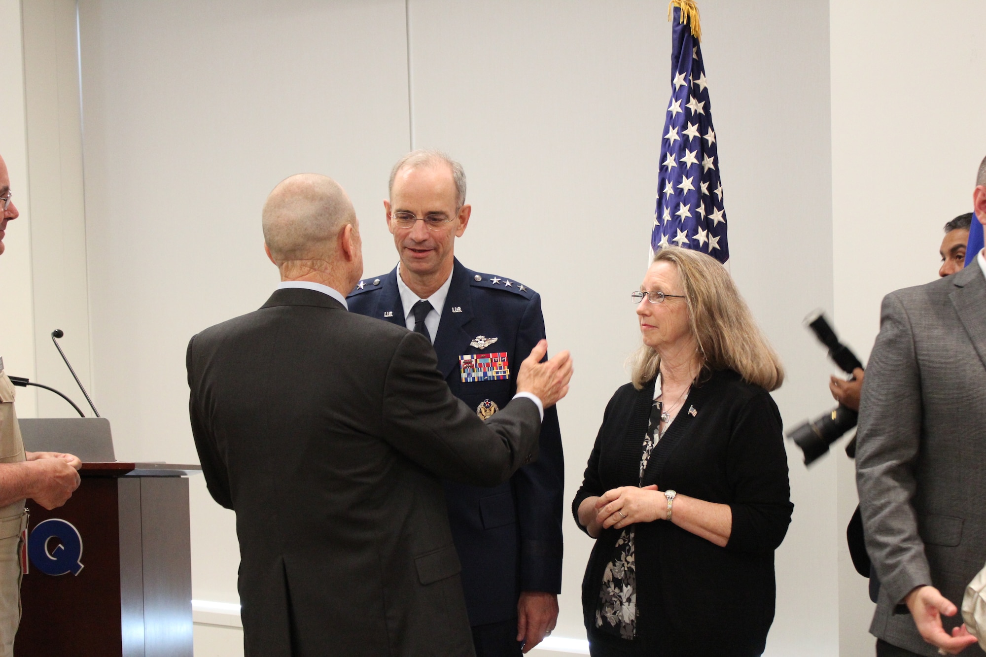 Lt. Gen. (Ret.) James Roudebush, the 19th Air Force Surgeon General, and Mrs. Debbie Ediger, congratulate Lt. Gen. Mark Ediger on his promotion and new assignment as Air Force Surgeon General June 8 at the Defense Health Headquarters.   (U.S. Air Force photo by Jonathan Stock.)  