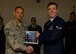 Chief Master Sgt. Robert Hughes, Materiel Maintenance Group chief enlisted manager, presents Airman 1st Class Tanner Hearren with a First Term Airmen Center graduation certificate at Holloman Air Force Base N.M. June 8, 2015. FTAC is a program that helps first term Airmen with the transition from technical school to an operational environment. It also gives the Airmen a warm welcome to Holloman from the majority of base agencies they will be working with on a daily basis.  (U.S. Air Force photo by Senior Airman Leah Ferrante/Released)  