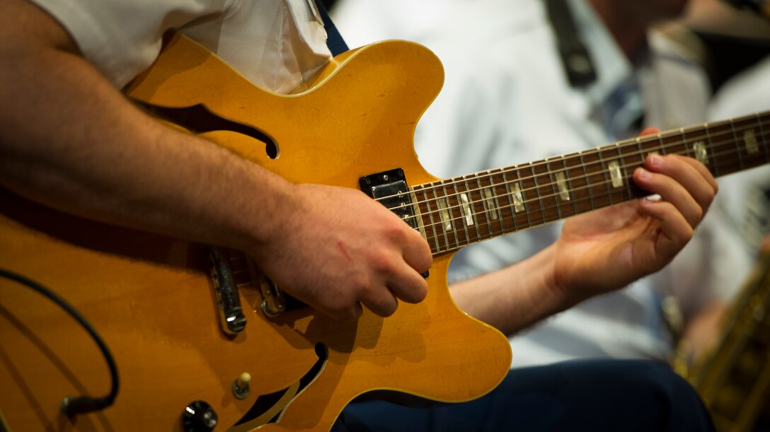 Staff Sgt. Michael Kramer, U.S. Army band member plays the guitar during the Great American Brass Band Festival at the Norton Center for the Arts in Danville, Ky., June 5, 2015. Kramer was temporarily filling in for the Airmen of Note guitarist. (U.S. Air Force photo by Staff Sgt. Chad C. Strohmeyer)(Released)