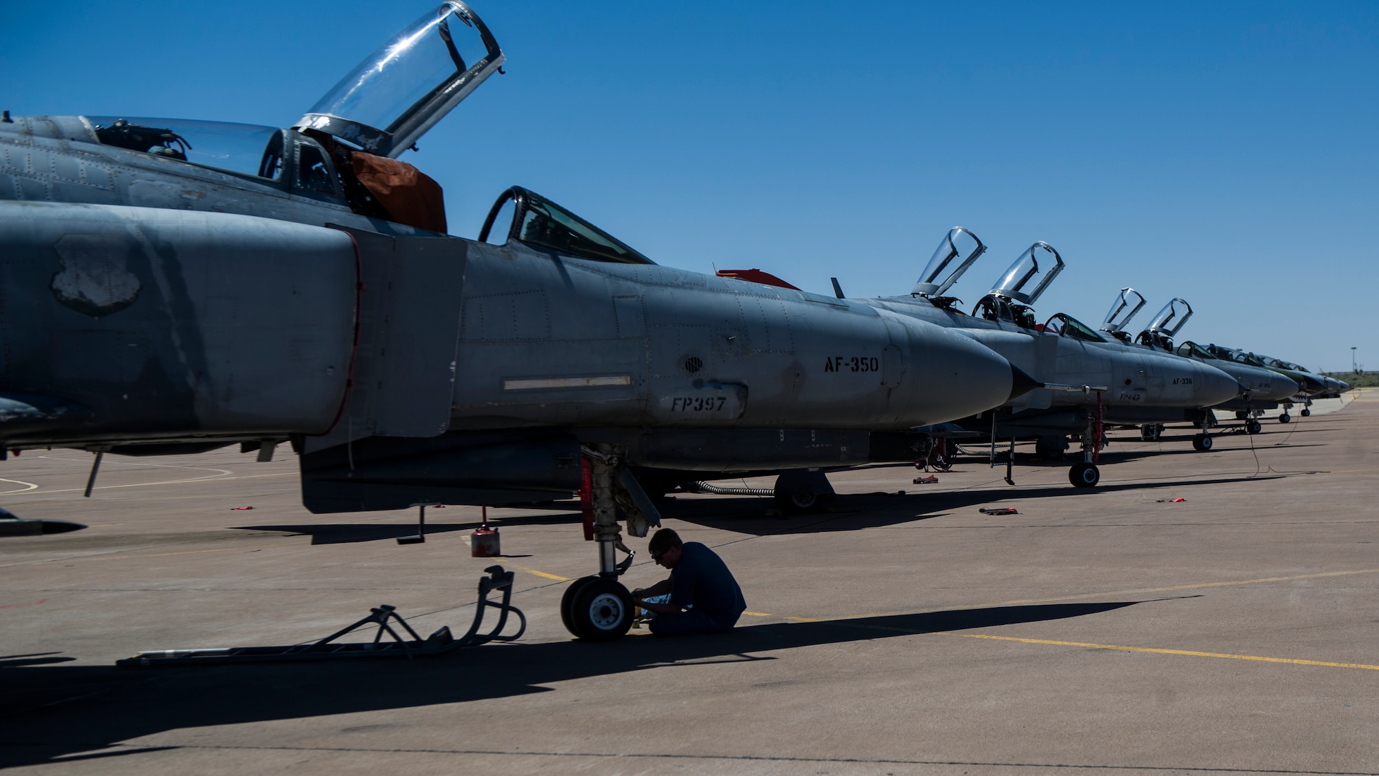 Mike Fogle, 82nd Aerial Target Squadron Detachment 1 mechanic, performs routine maintenance on a QF-4 Drone June 3, 2015 at Holloman Air Force Base N.M. The F-4 Phantom II first began flying in 1958 and is most famous for its performance in the Vietnam War. The F-4 officially retired in 1996 and now all operational Air Force F-4s have been converted to QF-4 Drones, which serve solely as remotely controlled unmanned targets for air-to-air and ground-to-air weapons systems evaluations, development and testing.  QF-4s can also be flown as a conventionally manned fighter.  (U.S. Air Force photo by Airman 1st Class Emily A. Kenney/Released) 