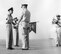 The guidon for the Headquarters Squadron, 3595th Flying Training Group can be seen during a ceremony on the flightline at Nellis Air Force Base, Nev., in 1956. Today's guidon traces its heritage back to smaller flags used by cavalry units in Europe during the late 1700s and early 1800s; these were used by squadrons within a larger regimental formation both on the battle field and in camps. (Courtesy photo) 
