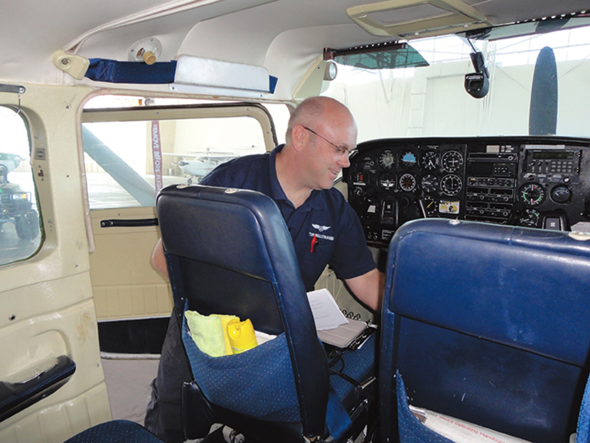 Capt. Tom Billstrand, a pilot from Civil Air Patrol’s Albuquerque Senior Squadron II, performs a pre-flight check of an aircraft during a statewide search-and-rescue exercise at Kirtland May 15. The exercise is being held for members to practice skills ahead of an operations evaluation by the U.S. Air Force scheduled for November. (Photo by Ryan Stark) 