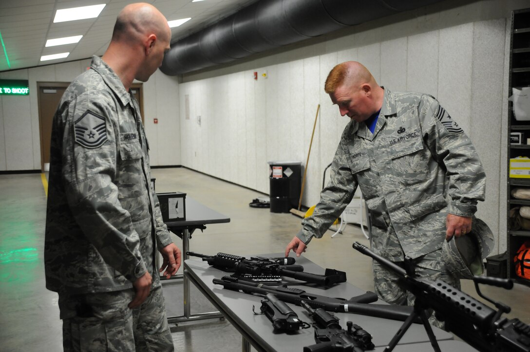 Chief Master Sgt. Michael Thorpe, 22nd Air Force Command Chief receives a weapons brief from Master Sgt. Stephen Houseman, noncommissioned officer in charge, 914 Security Forces Squadron Combat Arms Training and Maintenance, at Niagara Falls Air Reserve Station on June 6, 2015. Thorpe toured the installation with Maj. Gen. Stayce Harris 22nd Air Force Commander and visited with Airmen across the Wing. (U.S. Air Force photo by Tech. Sgt. Stephanie Sawyer)  