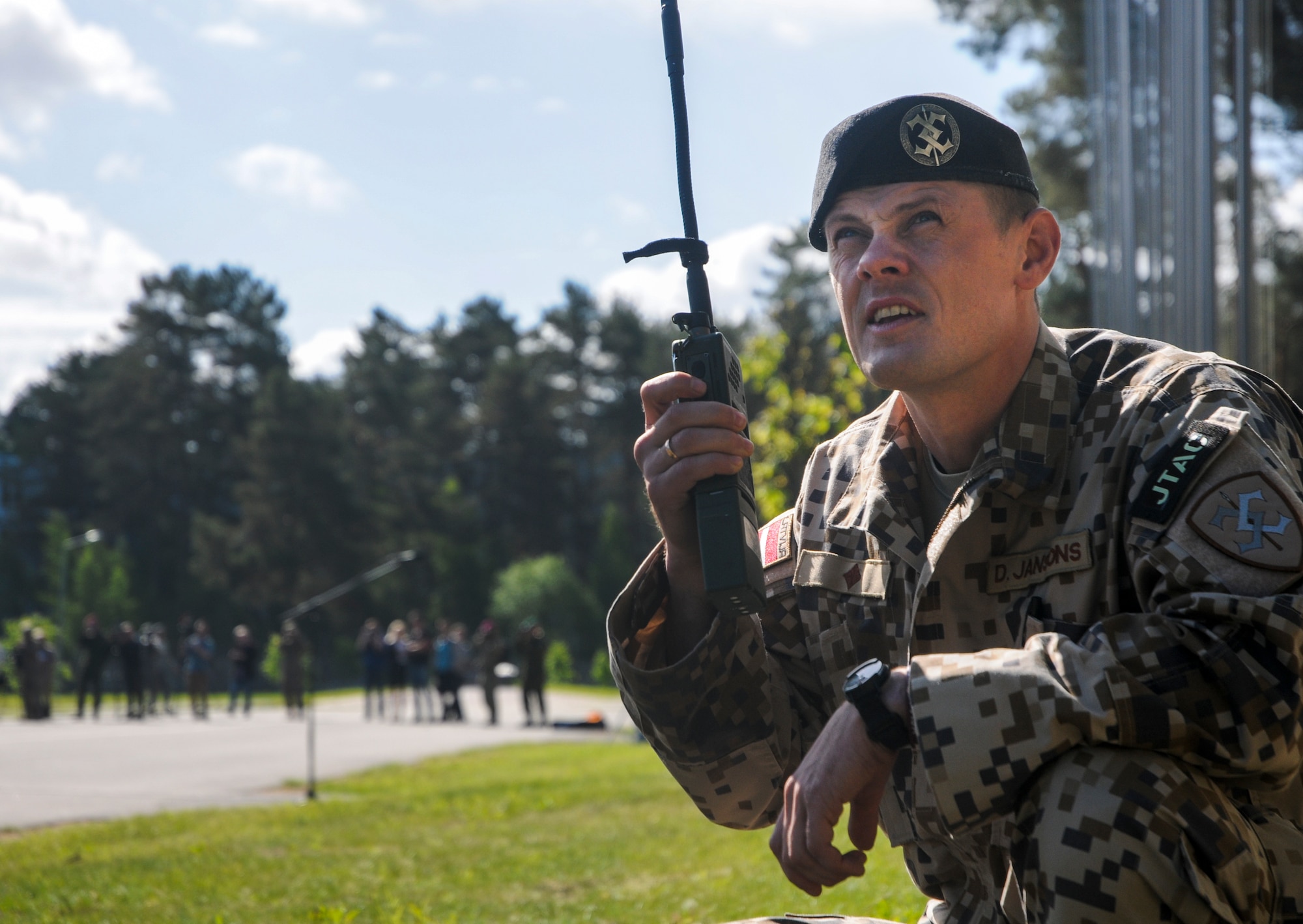Maj. Dans Jansons, Latvian Land Force Brigade Combat Support Battalion Tactical Air Controller Party commander, calls a U.S. Air Force A-10 Thunderbolt II from the Maryland Air National Guard for a flyover the opening ceremonies June 8, 2015, Adazi Training Area, Latvia. More than 6,000 service members are participating in Saber Strike 15 an annual multinational exercise designed to strengthen and develop interoperability and friendships between Baltic Area regions and NATO members to ensure regional security. (U.S. Air Force photo/ Capt Chase P. McFarland)