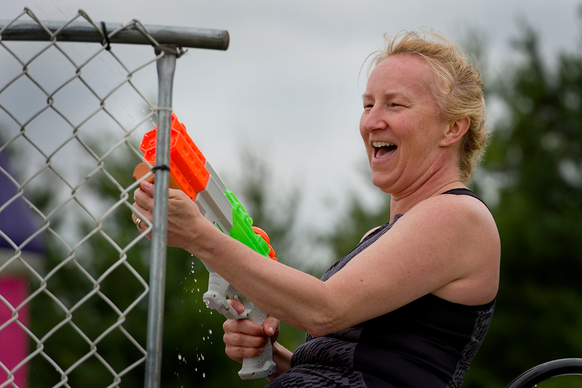 Col. Therese Kern, 434th Aerospace Medicine Squadron, shoots a water cannon at a would-be dunker as she sits atop the dunk tank at Grissom Air Reserve Base, Ind., June 6, 2015. Airmen and their families enjoyed an afternoon of fun and festivities designed to build camaraderie and help loved one see what their Airmen do at the base. (U.S. Air Force photo/Tech. Sgt. Douglas Hays)