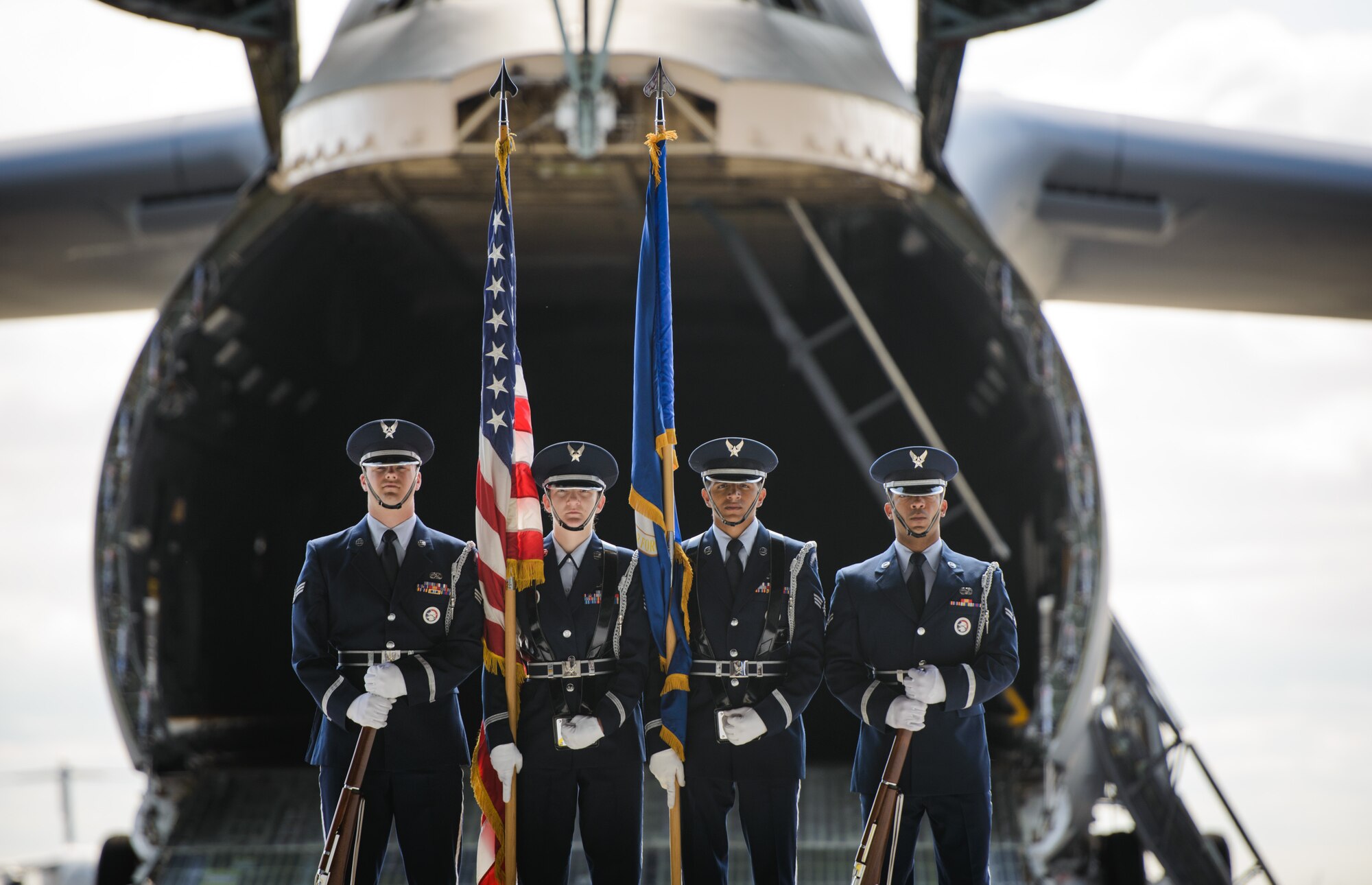 A color guard detail stands in front of a C-5M Super Galaxy aircraft in preparation for a June 1, 2015, retirement ceremony at Travis Air Force Base, Calif. Airmen from the Travis Honor Guard supported 1,807 ceremonies in 2014, providing an important service that ensures honor and dignity for the American flag, U.S. Air Force flag and flags of visiting dignitaries' native countries. (U.S. Air Force photo by Ken Wright/Released)