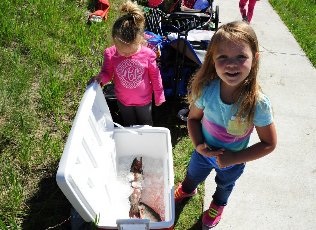 Jaycee, 5, daughter of Staff Sgt. Colton Chandler, 12th Missile Squadron facility manager proudly displays her catch during Kids Fishing Day, Jun. 6, 2015, at Pow Wow Park, Malmstrom Air Force Base, Mont. National Fishing and Boating Week is the week of June 6-14, 2015. (U.S. Air Force photo/2nd Lt. Annabel Monroe)