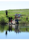 Team Malmstrom members participate in Kids Fishing Day, Jun. 6, 2015, at Pow Wow Park, Malmstrom Air Force Base, Mont.  The pond was stocked by the U.S. Fish and Wildlife Service with 12 inch and larger trout, as well as three to five pound rainbow trout. (U.S. Air Force photo/2nd Lt. Annabel Monroe)