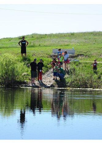 Team Malmstrom members participate in Kids Fishing Day, Jun. 6, 2015, at Pow Wow Park, Malmstrom Air Force Base, Mont.  The pond was stocked by the U.S. Fish and Wildlife Service with 12 inch and larger trout, as well as three to five pound rainbow trout. (U.S. Air Force photo/2nd Lt. Annabel Monroe)