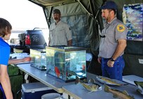 Educational activity tents included an aquarium display set up by Fish and Wildlife Offices and rangers during National Fishing and Boating Week, Jun. 6, 2015, at Pow Wow Park, Malmstrom Air Force Base, Mont. All children at Kids Fishing Day had the opportunity to receive lures, bobbers and temporary fish tattoos. (U.S. Air Force photo/2nd Lt. Annabel Monroe)