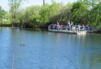 Team Malmstrom members participate in National Fishing and Boating Week, Jun. 6, 2015, at Pow Wow Park, Malmstrom Air Force Base, Mont.  During Kids Fishing Day the pond was stocked by the U.S. Fish and Wildlife Service with 12 inch and larger trout, as well as three to five pound rainbow trout. (U.S. Air Force photo/2nd Lt. Annabel Monroe)