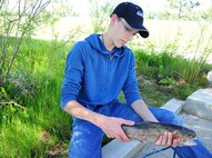 Briton Bare, 17, son of Britt Bare, a Kids Fishing Day volunteer from the 341st Civil Engineering Squadron housing management assistant, proudly displays his catch, Jun. 6, 2015, at Pow Wow Park, Malmstrom Air Force Base, Mont. National Fishing and Boating Week is the week of June 6-14, 2015. (U.S. Air Force photo/2nd Lt. Annabel Monroe)
Kids catch fish plus fun
