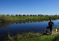 Team Malmstrom members participate in National Fishing and Boating Week, Jun. 6, 2015, at Pow Wow Park, Malmstrom Air Force Base, Mont.  To ensure there were plenty of fish to catch the U.S. Fish and Wildlife Service stocked the pond with 12 inch and larger trout, as well as three to five pound rainbow trout. (U.S. Air Force photo/2nd Lt. Annabel Monroe)