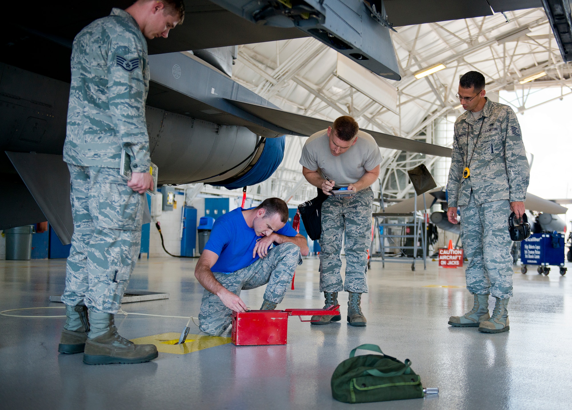 Senior Airman Jonathan Atstupenas and Staff Sgt. Taleisan Colby, 96th Aircraft Maintenance Squadron Blue, verify tools during the second quarter load crew competition June 5 at Eglin Air Force Base, Fla.  The blue team lost the competition to the Red A-10 Thunderbolt II team that consisted of loading the missile and two BDU-50s.  (U.S. Air Force photo/Samuel King Jr.)