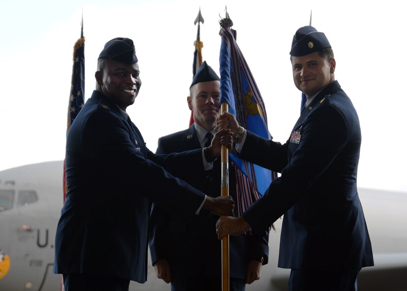 U.S. Air Force Col. Earl Scott, left, 100th Maintenance Group commander, gives command of the 100th Maintenance Squadron to U.S. Air Force Maj. Gerard Carisio, 100th MXS commander, during the 100th MXS change of command ceremony May 28, 2015, on RAF Mildenhall, England. The passing of the unit guidon during a change of command ceremony is a symbolic representation of passing authority to the incoming commander for all to see. (U.S. Air Force Senior Airman Kyla Gifford/Released)