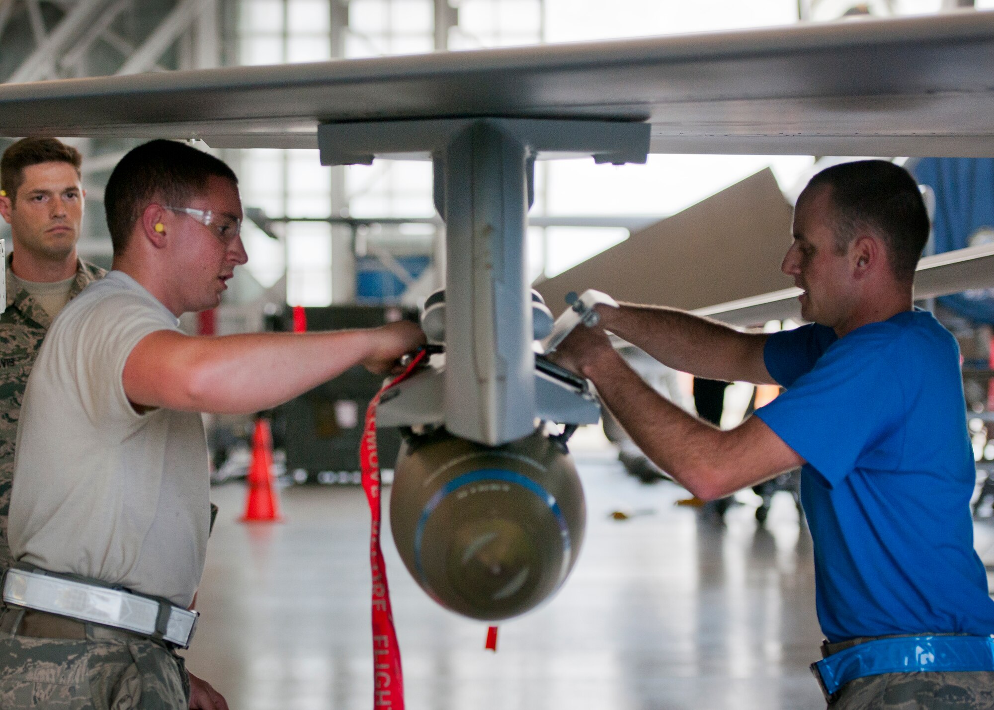 Senior Airmen Trey Riley and Jonathan Atstupenas, 96th Aircraft Maintenance Squadron Blue, secure a BDU-50 onto an F-16 Fighting Falcon during the second quarter load crew competition June 5 at Eglin Air Force Base, Fla.  The blue team lost the competition to the Red A-10 Thunderbolt II team that consisted of loading the missile and two BDU-50s.  (U.S. Air Force photo/Samuel King Jr.)