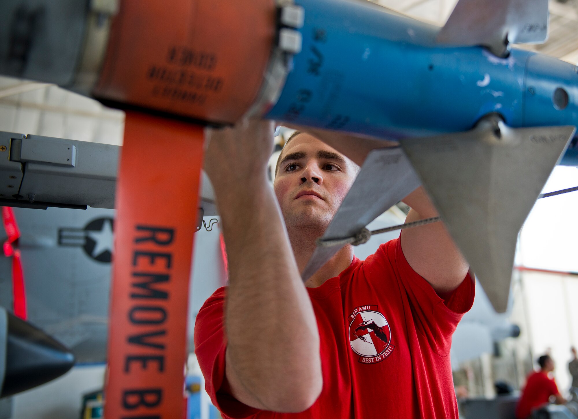 Airman 1st Class James Schmeits, 96th Aircraft Maintenance Squadron Red, secures an AIM-9 to an A-10 Thunderbolt II during the second quarter load crew competition June 5 at Eglin Air Force Base, Fla.  This was the first time in many years the Red team used an A-10 as their weapons load aircraft.  The Red team won the competition against the Blue F-16 Fighting Falcon team.  (U.S. Air Force photo/Samuel King Jr.)