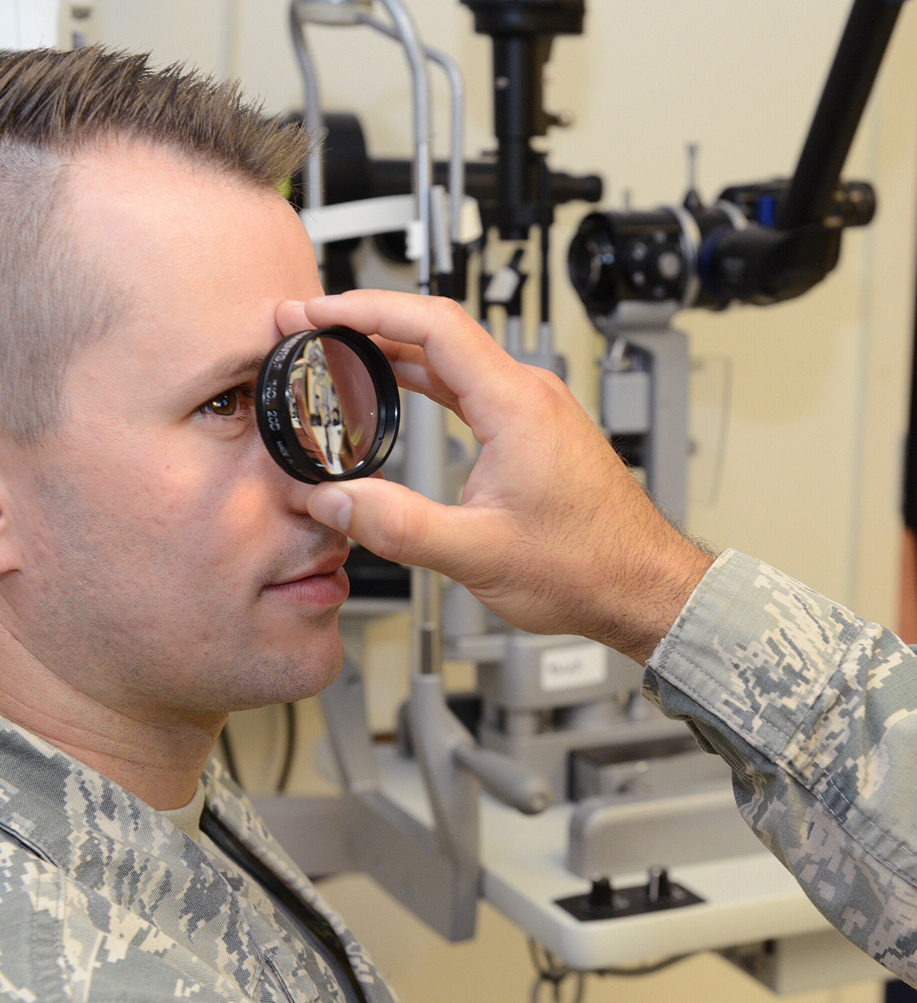 Senior Airman Derek Clinger receives an eye exam from Capt. Mathew Tholl, 78th Medical Group optometrist, at the optometry clinic here. The Optometry Clinic's acute care services are available to patients on a self-referral basis or by referral through their primary care manager or other medical provider for complex or urgent conditions. (U.S. Air Force photo by Tommie Horton) 