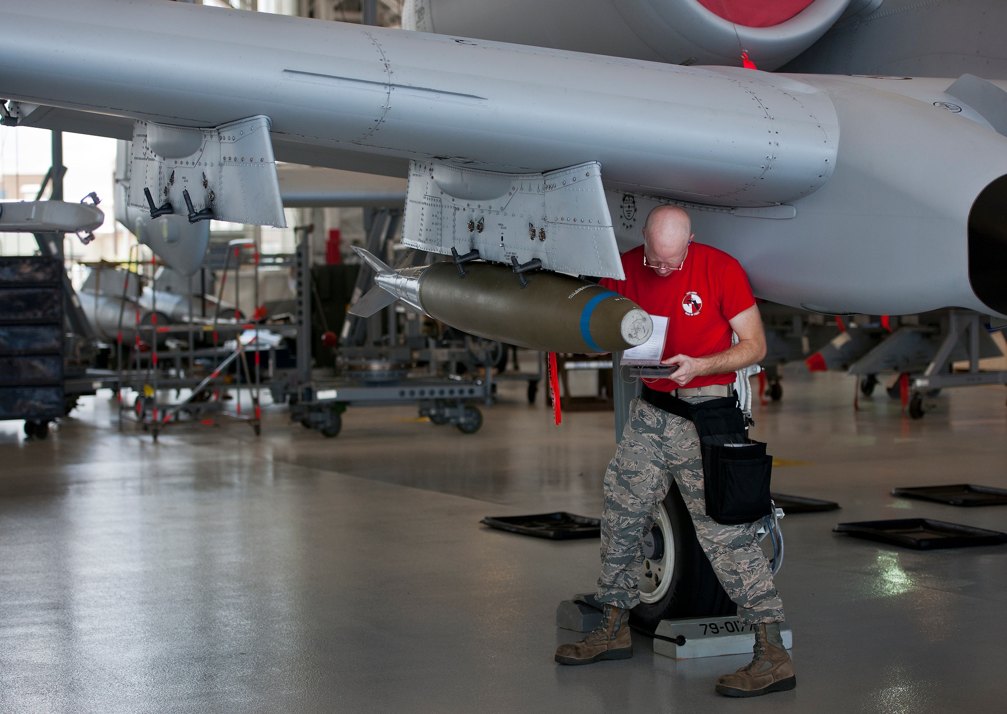 Staff Sgt. Tyler Marking, 96th Aircraft Maintenance Squadron Red, verifies the BDU-50 weapon load on an A-10 Thunderbolt II with his checklist during the second quarter load crew competition June 5 at Eglin Air Force Base, Fla.  This was the first time in many years the Red team used an A-10 as their weapons load aircraft.  The Red team won the competition against the Blue F-16 Fighting Falcon team.  (U.S. Air Force photo/Samuel King Jr.)
