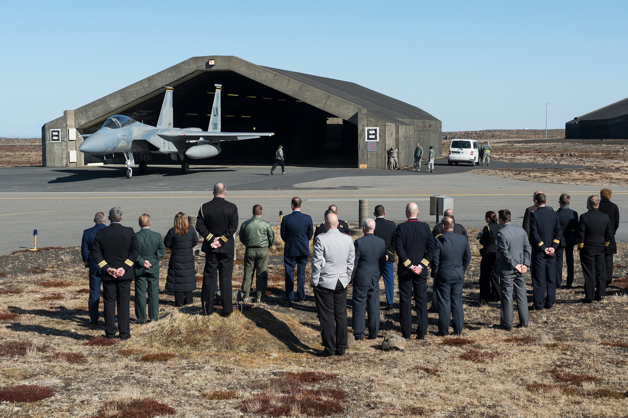 Members of the annual Arctic Security Forces Roundtable watch a training scramble of an F-15C Eagle fighter aircraft at Keflavik International Airport, Iceland. Representatives from 11 nations across Europe and North America met for the ASFR in order to promote regional understanding and enhance multilateral security operations within the Arctic area. (U.S. Air Force photo by Staff Sgt. Chad Warren/Released)