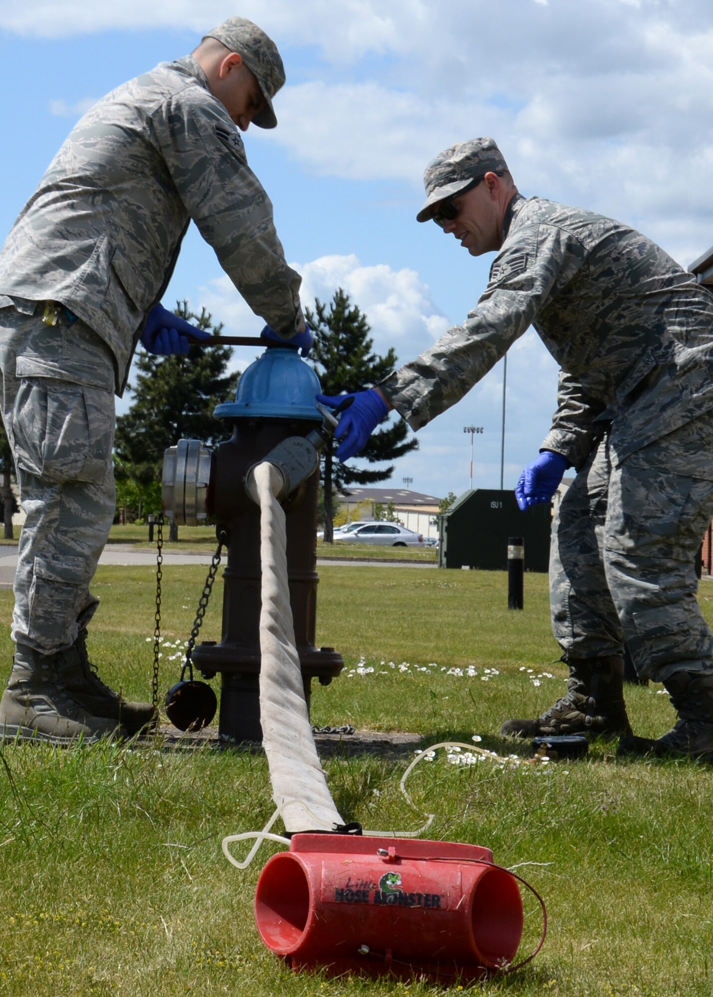 U.S. Air Force Airman 1st Class Jarrad Faulkner, left, from Hamilton, Ohio, and U.S. Air Force Senior Airman Joshua Slater, from Springfield, Mo., both 100th Civil Engineer Squadron water and fuels system maintenance journeymen, perform fire hydrant flow testing June 3, 2015, on RAF Mildenhall, England. The Airmen were ensuring the base has the necessary water suppression capabilities to fight a fire in the event of an emergency. (U.S. Air Force photo by Gina Randall/Released)