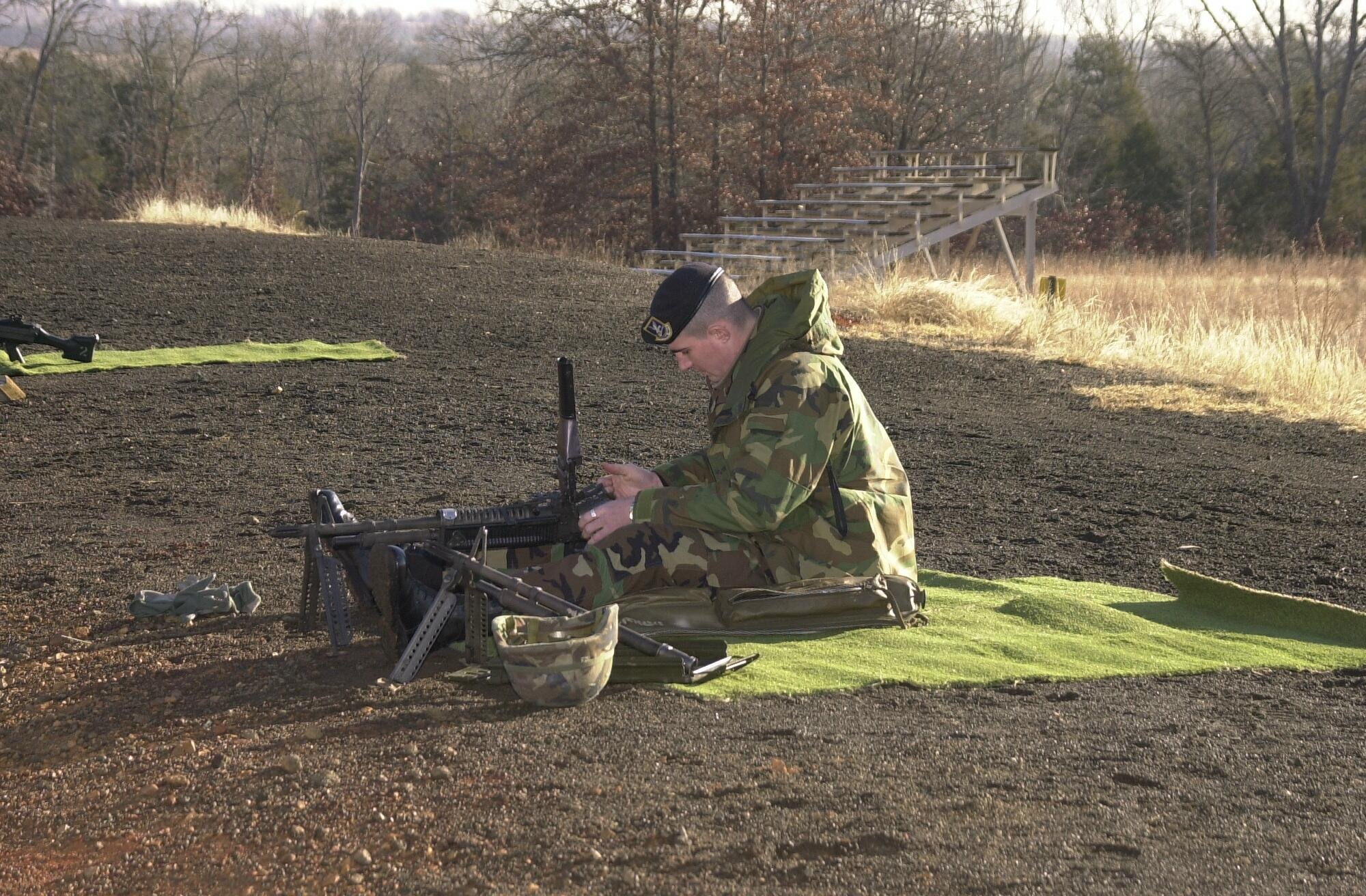 Senior Master Sgt. Asa Carter changes the barrel on the M-60 machine gun at Fort Chaffee Joint Maneuver Training Center, Ark., Jan. 8, 2002. (U.S. Air National Guard photo by Staff Sgt. Andrew Hammands Jr./released)