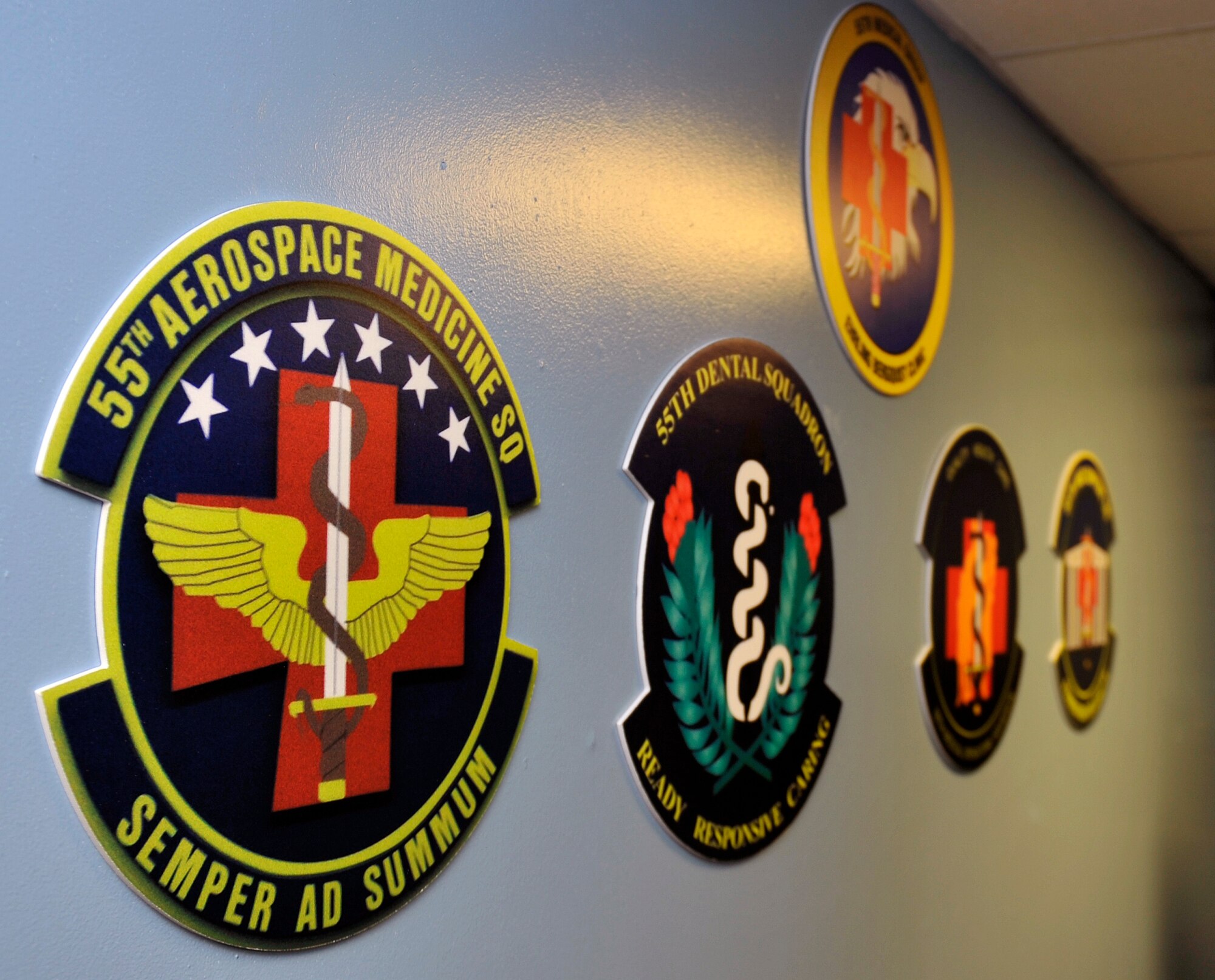 The 55th Medical Group and its respective squadron’s emblems hang in the basement dayroom of the Kisling Hall Dormitory June 3. The 55th MDG Top Three funded the signs and hopes to continue to make quality of life better for the Air Force’s future leaders. (U.S. Air Force photo by Jeff Gates)