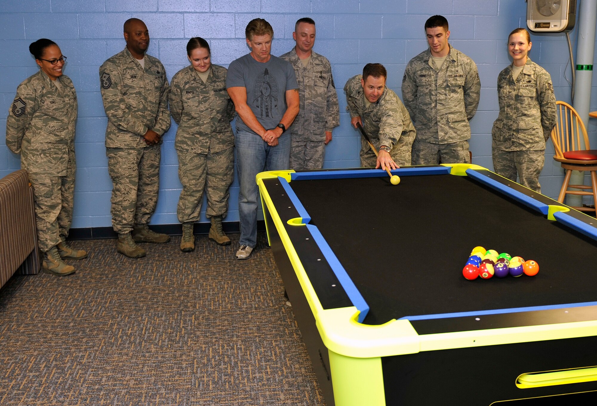 U.S. Air Force Col. Stephen Mounts, 55th Medical Group commander, makes the first break on the brand new pool table in the Kisling Hall dormitory basement dayroom June 3.  Various member of the 55th MDG came together to renovate the room and make it better for the Airmen residing in the dormitory. (U.S. Air Force photo by Jeff Gates)