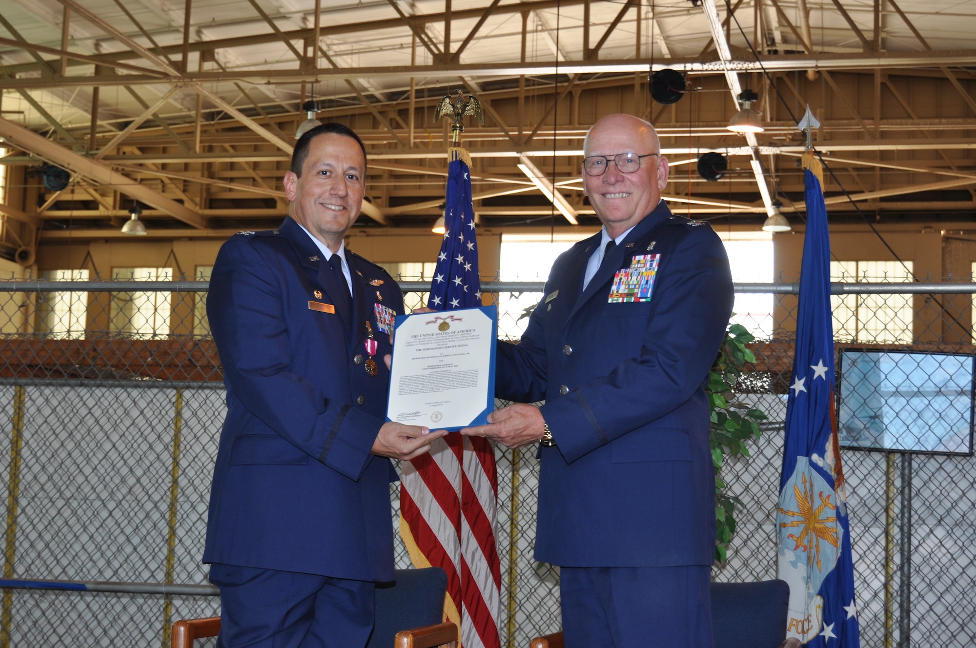 Col. Anthony Pena, (left) 433rd Medical Squadron commander, receives his second career Meritorious Service Medal from retired Col. Wayne Olson, the presiding official for Pena's retirement ceremony, held at Joint Base San Antonio-Lackland June 6. Pena is retiring after more than 32 years of service in the Air Force Reserves. (U.S. Air Force photo/Senior Airman Bryan Swink) 