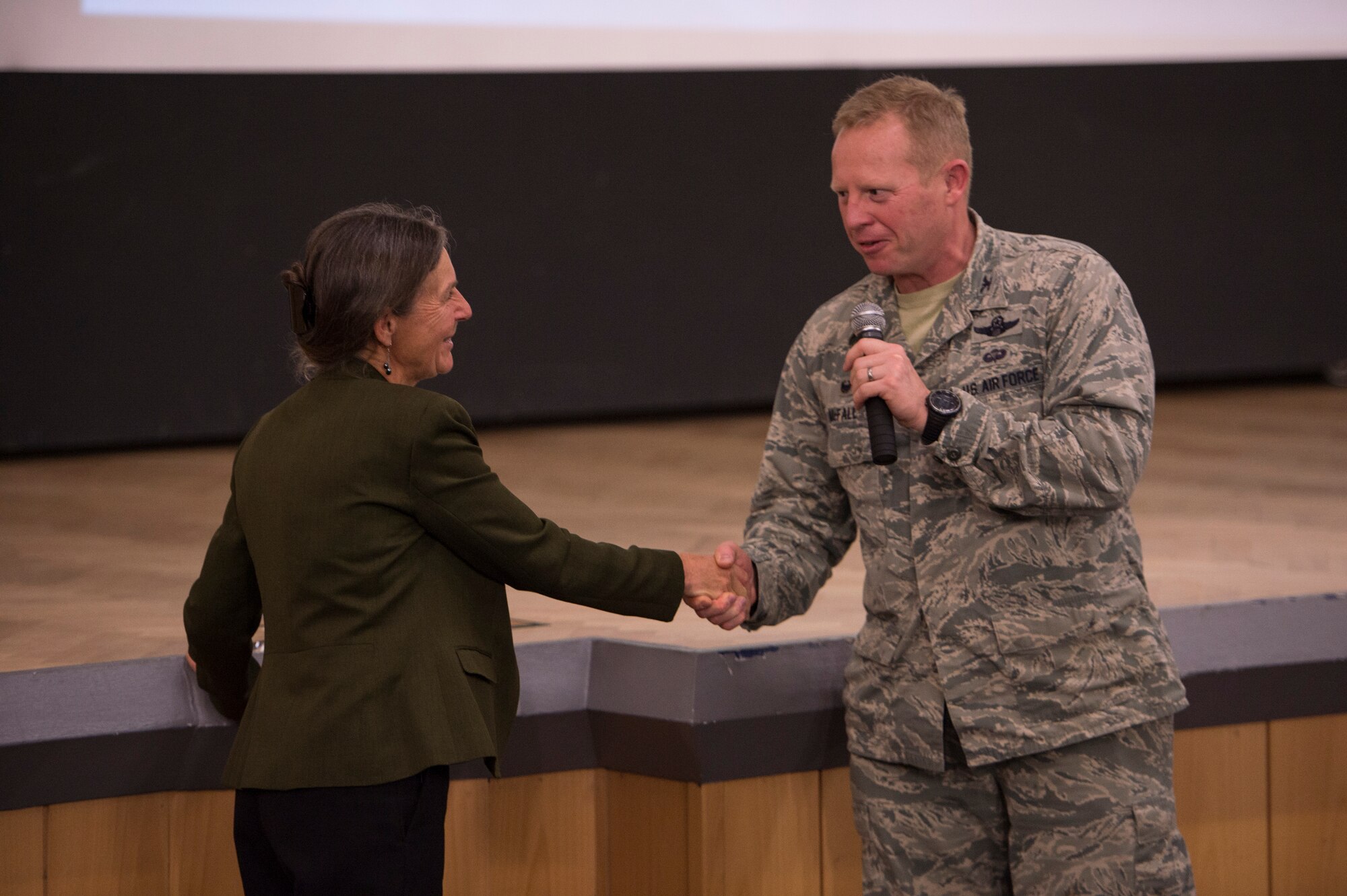 U.S. Air Force Col. Joe McFall, 52nd Fighter Wing commander, presents a coin to retired U.S. Army Brig. Gen. Rhanda Cornum, a Department of Defense resiliency consultant, at the base theater on Spangdahlem Air Base, Germany, June 4, 2015, during the 52nd Fighter Wing’s Resiliency Day. McFall thanked Cornum for being the key speaker kicking off the base’s resiliency themed events for the day. (U.S. Air Force photo by Staff Sgt. Christopher Ruano/Released)