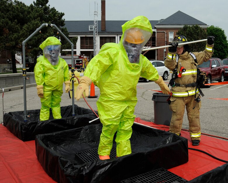 150605-Z-MI929-014 – Emergency personnel receive a scrub down during a training exercise at Selfridge Air National Guard Base, Mich., June 5, 2015. During the exercise, a smoke machine was used to create a simulated cloud of chlorine gas after an industrial accident. Firefighters and other base personnel trained in the steps necessary to respond to such an emergency. Airmen at Selfridge conduct a variety of training exercises every year to be able to respond to local emergencies and/or to deploy to forward locations. (U.S. Air National Guard photo by Terry Atwell)