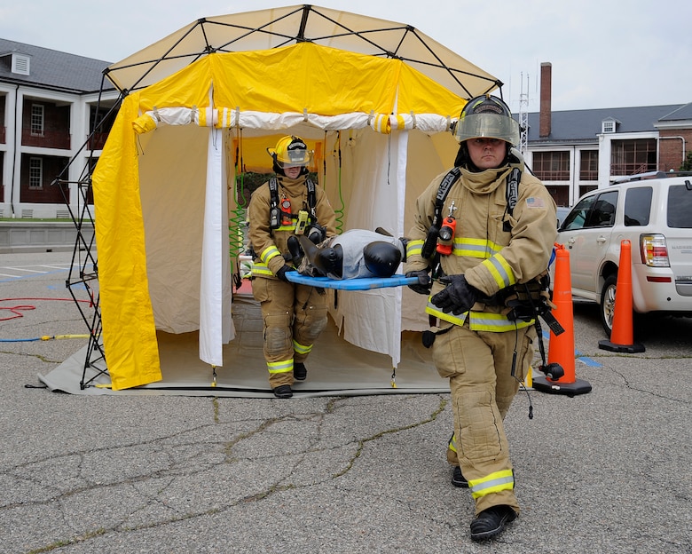 150605-Z-MI929-016 – Selfridge firefighters carry a mannequin out of a decontamination tent during a training exercise at Selfridge Air National Guard Base, Mich., June 5, 2015. During the exercise, a smoke machine was used to create a simulated cloud of chlorine gas after an industrial accident. Firefighters and other base personnel trained in the steps necessary to respond to such an emergency. Airmen at Selfridge conduct a variety of training exercises every year to be able to respond to local emergencies and/or to deploy to forward locations. (U.S. Air National Guard photo by Terry Atwell)