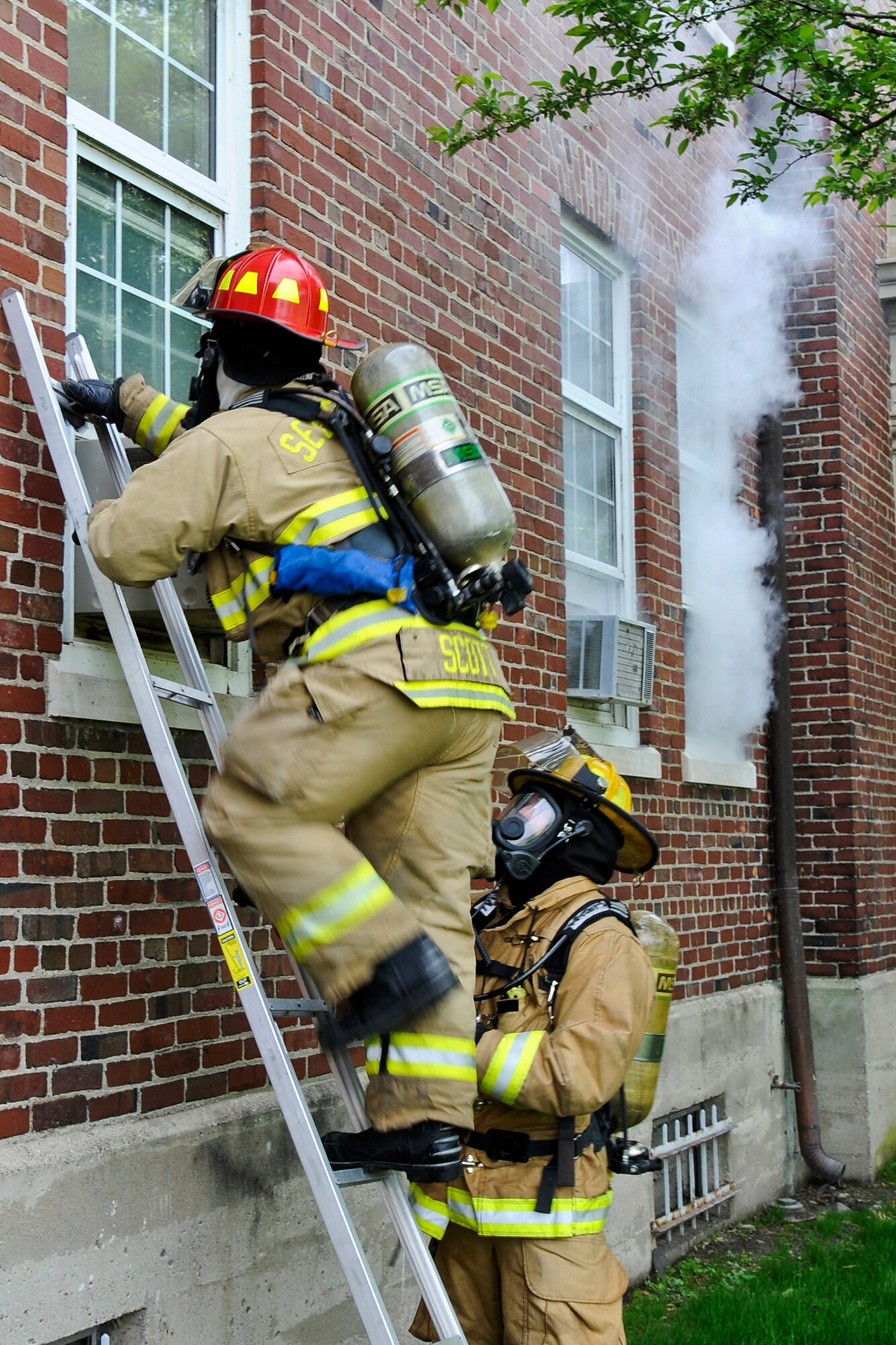 150605-Z-MI929-008 – Firefighters look into a building during a training exercise at Selfridge Air National Guard Base, Mich., June 5, 2015. During the exercise, a smoke machine was used to create a simulated cloud of chlorine gas after an industrial accident. Firefighters and other base personnel trained in the steps necessary to respond to such an emergency. Airmen at Selfridge conduct a variety of training exercises every year to be able to respond to local emergencies and/or to deploy to forward locations. (U.S. Air National Guard photo by Terry Atwell)