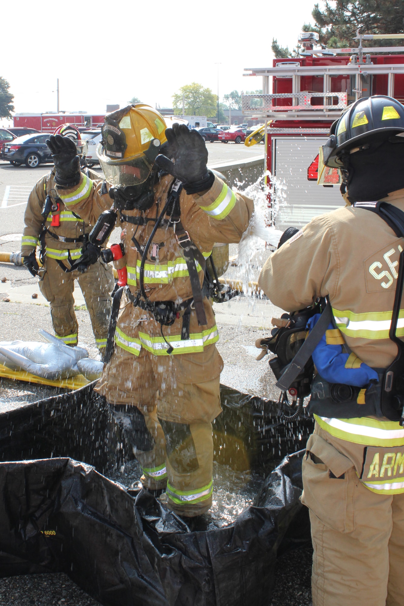 150605-Z-VA676-003 – A Selfridge firefighter is “decontaminated” after participating in a training exercise in which firefighters and other personnel responded to a room that was filled with simulated chlorine gas at Selfridge Air National Guard Base, Mich., June 5, 2015. Airmen at Selfridge conduct a variety of training exercises every year to be able to respond to local emergencies and/or to deploy to forward locations. (U.S. Air National Guard photo by Tech. Sgt. Dan Heaton)
